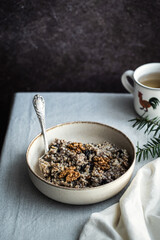 Kutia - essential traditional Ukrainian Christmas sweet dish prepared for Christmas Eve supper and cup of  uzvar on linen tablecloth.