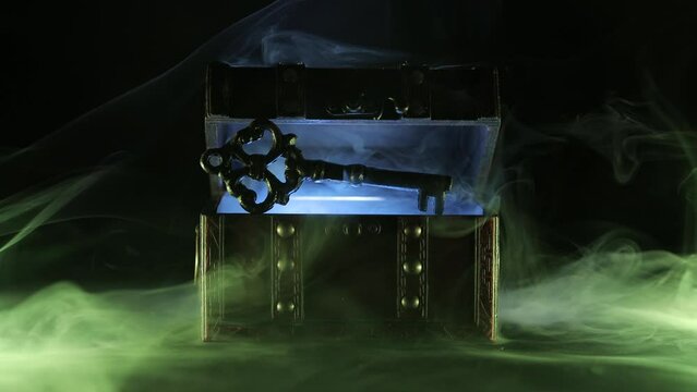 Mysterious chest and key on a dark background. Panoramic mockup for your logo. Horizontal banner with copy space for popular social media website cover image.