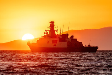 Fototapeta premium Coast guard ship flooded with sunset light in a bay of Aegean sea