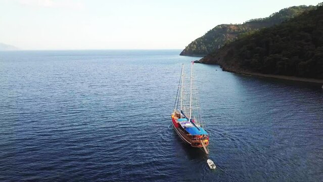 Aerial tracking a gulet type sailing yacht. Ekincik Bay Landscape; One of the most well known departure and arrival points for&nbsp;Blue Cruise Tours. A fantastic experience between swimming and eating
