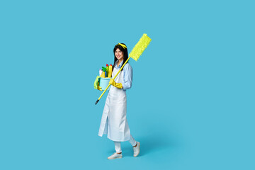 woman in rubber gloves and cleaner apron with cleaning supplies