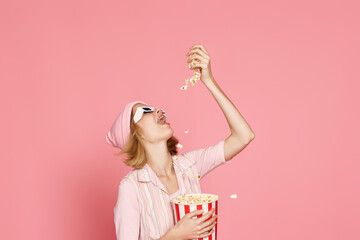 pleased blonde woman in t-shirt and hat eating popcorn - Powered by Adobe