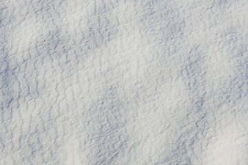 Obraz premium The surface of natural snow is illuminated by the Sun. Close up top view