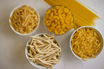 Dry pasta different on a light background