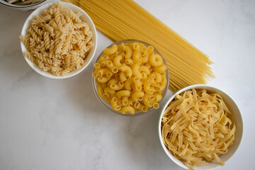 Dry pasta different on a light background