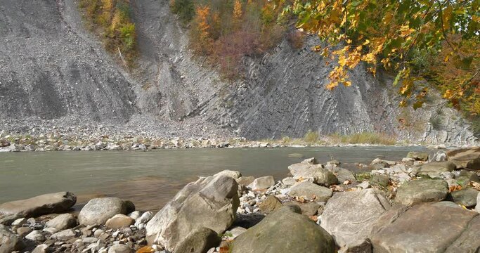 Rocky bank of Prut river and mountain folds in Yaremche city, western Ukraine, known as Yaremche folds, biggest outcrop of Stryi formation in Europe, are gothic or chevron types. Cinema 4K 60fps video