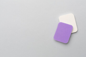 Beauty blenders on color background, top view