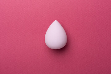 Beauty blender on color background, top view