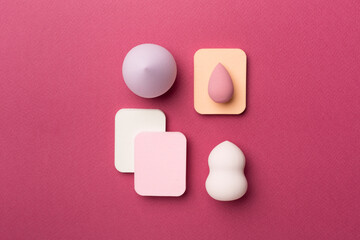 Beauty blenders on color background, top view