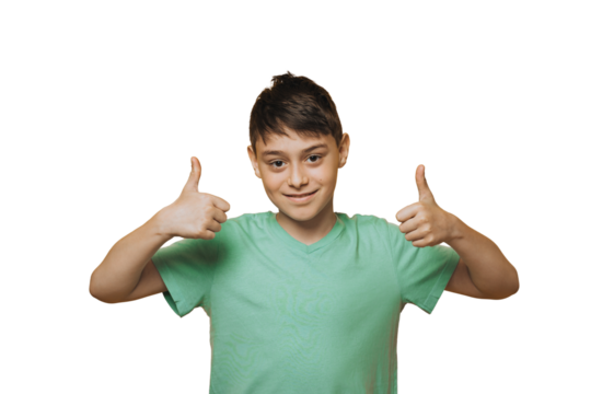 Portrait of attractive young school boy dressed in a green t-shirt, cute smiling showing thumbs up over transparent background, isolated. Copy space. Success people emotions.