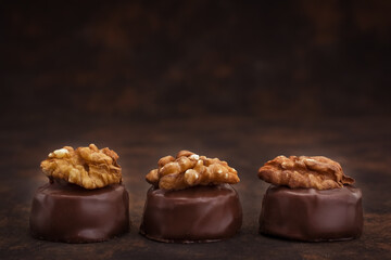 Close up of homemade with dark chocolate pralines filled with walnuts and  marzipan