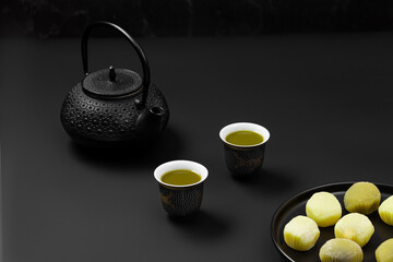 Obraz na płótnie Canvas Matcha tea and mochi on black background