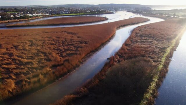 Aerial shot flying over wetlands and estuary of River Exe in Devon, UK