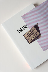 softcover book with part of the title "The End" and a small note: "enjoy every moment"