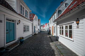 Old town Gamle Stavanger with white timber houses in Norway, during sunshine and blue sky - 559241390