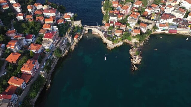Historical Kemere Bridge at Amasra Resort Town in Bartin, Turkey . Sea view cottages. Aerial
