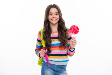 Teenage girl with candy lollipop, happy child 12, 13, 14 years old eating big sugar lollipop, sweets candy. Happy girl face, positive and smiling emotions.