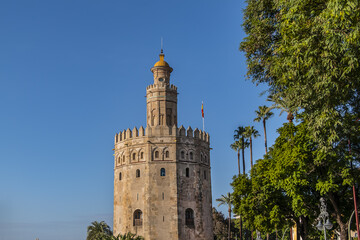 Fototapeta na wymiar Golden Tower (Torre del Oro, from 13th century) located on the left bank of Guadalquivir River - historic military observation tower and Spanish cultural heritage monument. Seville, Andalusia, Spain.