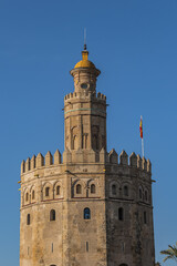 Obraz premium Golden Tower (Torre del Oro, from 13th century) located on the left bank of Guadalquivir River - historic military observation tower and Spanish cultural heritage monument. Seville, Andalusia, Spain.