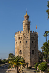Fototapeta na wymiar Golden Tower (Torre del Oro, from 13th century) located on the left bank of Guadalquivir River - historic military observation tower and Spanish cultural heritage monument. Seville, Andalusia, Spain.