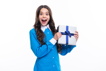 Emotional teenager child hold gift on birthday. Funny kid girl holding gift boxes celebrating happy New Year or Christmas.