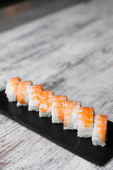 light salmon cheese sushi philadelphia on black desk white background