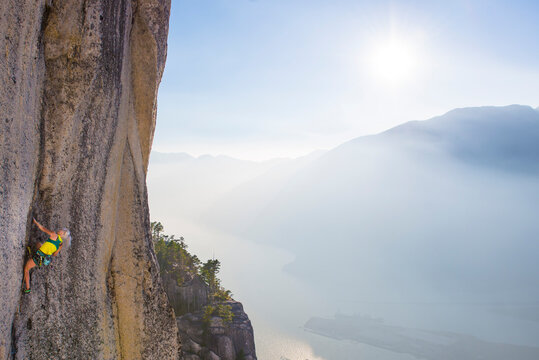 Rock climber climbing hard route on the Chief in Squamish