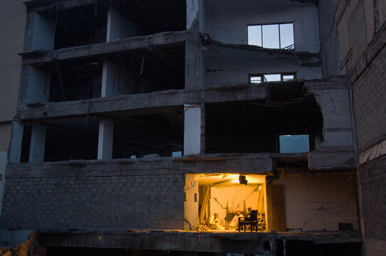 Men sit in the room of a destroyed hotel, Kashmir, Pakistan.