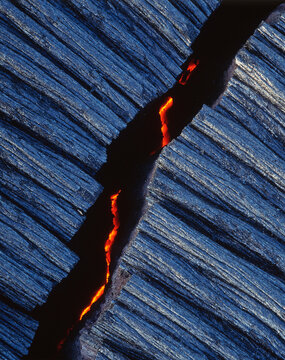 Fissure on rock shows lava flowing beneath