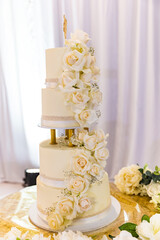 Beautiful white wedding cake decorating with white roses