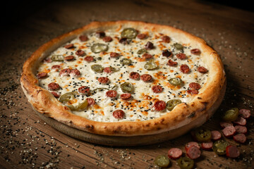 delicious jalapenos pizza with sausages. dark wooden table