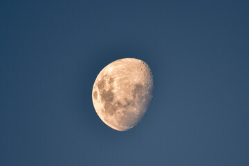 Moon in a light blue sky