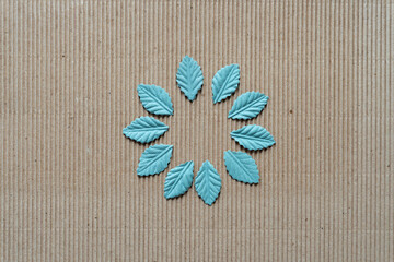 faux leaves on corrugated paper