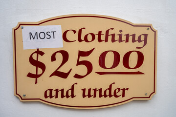 Sign for most clothing 25 dollars and under. Most covers up the word All. Funny sign
