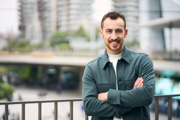 Portrait of confident smiling entrepreneur with arms crossed looking at camera. Successful business...