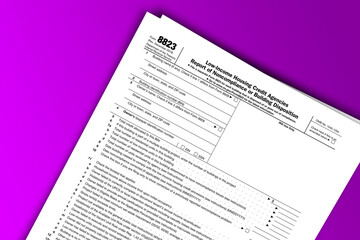 Fototapeta premium Form 8823 documentation published IRS USA 43597. American tax document on colored
