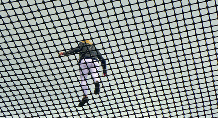 A young woman walks along the safety net at the top of the observation tower