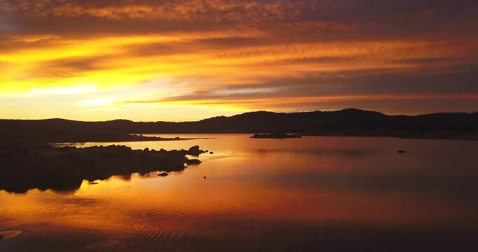 Vibrant clouds orange Lake Jindabyne aerial Drone Australia NSW Thredbo Perisher Jindabyne Stunning Epic incredible Sunrise Sunset  Colorful Still peaceful vibrant colors rocks lakeside