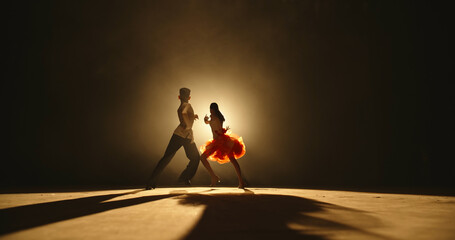 Talented asian kids showing ballroom dance on stage, on smoked black background - childhood dream,...