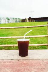 americano coffee on wood table with Mountain hill View background