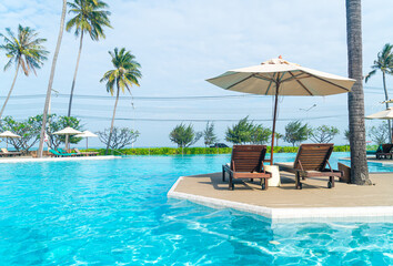 Fototapeta na wymiar umbrella with bed pool around swimming pool with ocean sea background