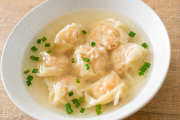 shrimp dumpling soup in white bowl