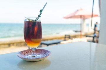 iced americano coffee peach with sea background