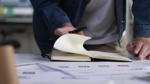Graphic designer drawing sketches logo design. The concept of a new brand. Professional creative occupation with idea.