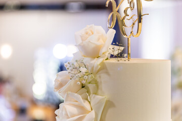 Beautiful white wedding cake decorated with white roses