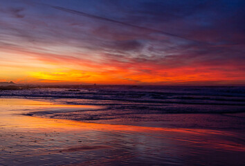 Naklejka na ściany i meble A beautiful sunset skies over the Pacific Ocean in California