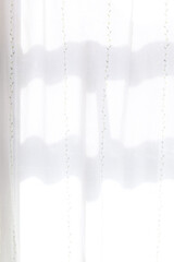 窓辺の日の光を浴びたカーテン