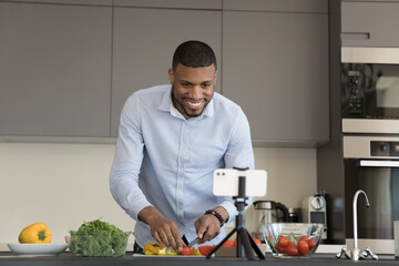 Food blog, on-line recipes. African vlogger record cooking class on smartphone camera, watch...