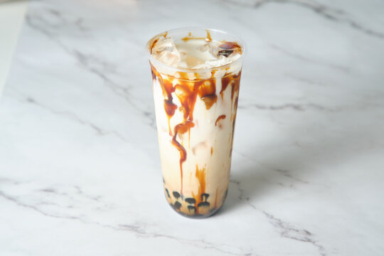 close up shot of a brown sugar milk tea on a marble table