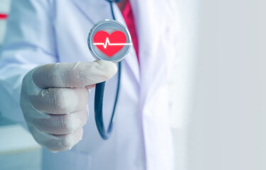 Close up of female doctor using stethoscope with red heartbeat icon and copy space. Hospital and patient care concept.